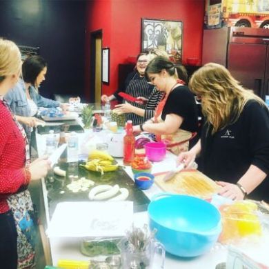 a group of people sitting at a table eating food