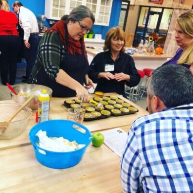 a group of people sitting at a table with food