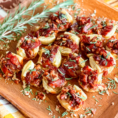a pizza sitting on top of a wooden cutting board