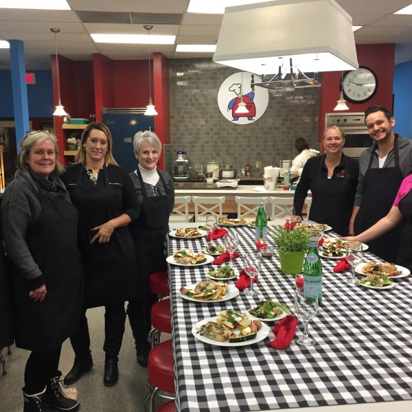 Daniel Beckius et al. standing around a table
