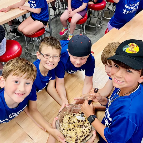 a group of people standing next to a child