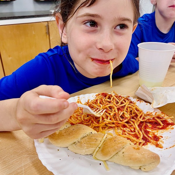 a person sitting at a table eating food