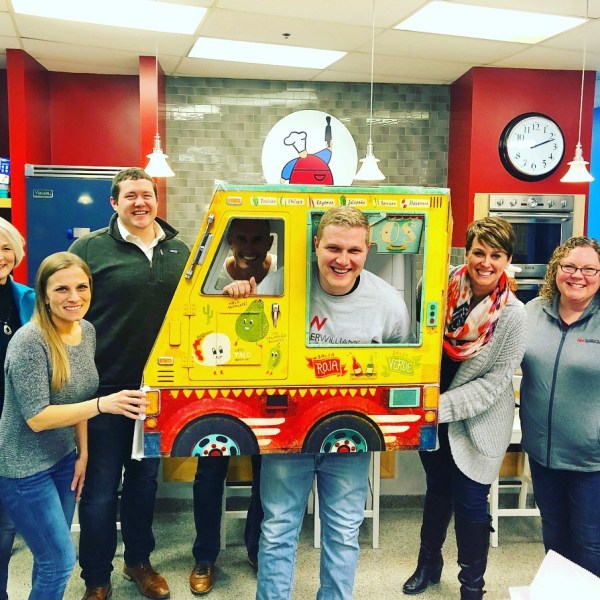 a person standing in front of a group of people posing for the camera