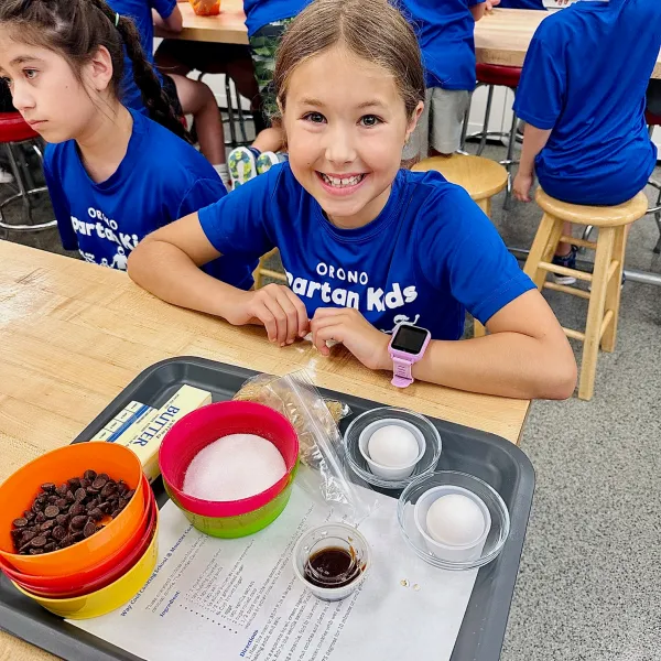 a young boy sitting on a table