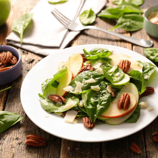 a table topped with a sandwich and salad on a plate