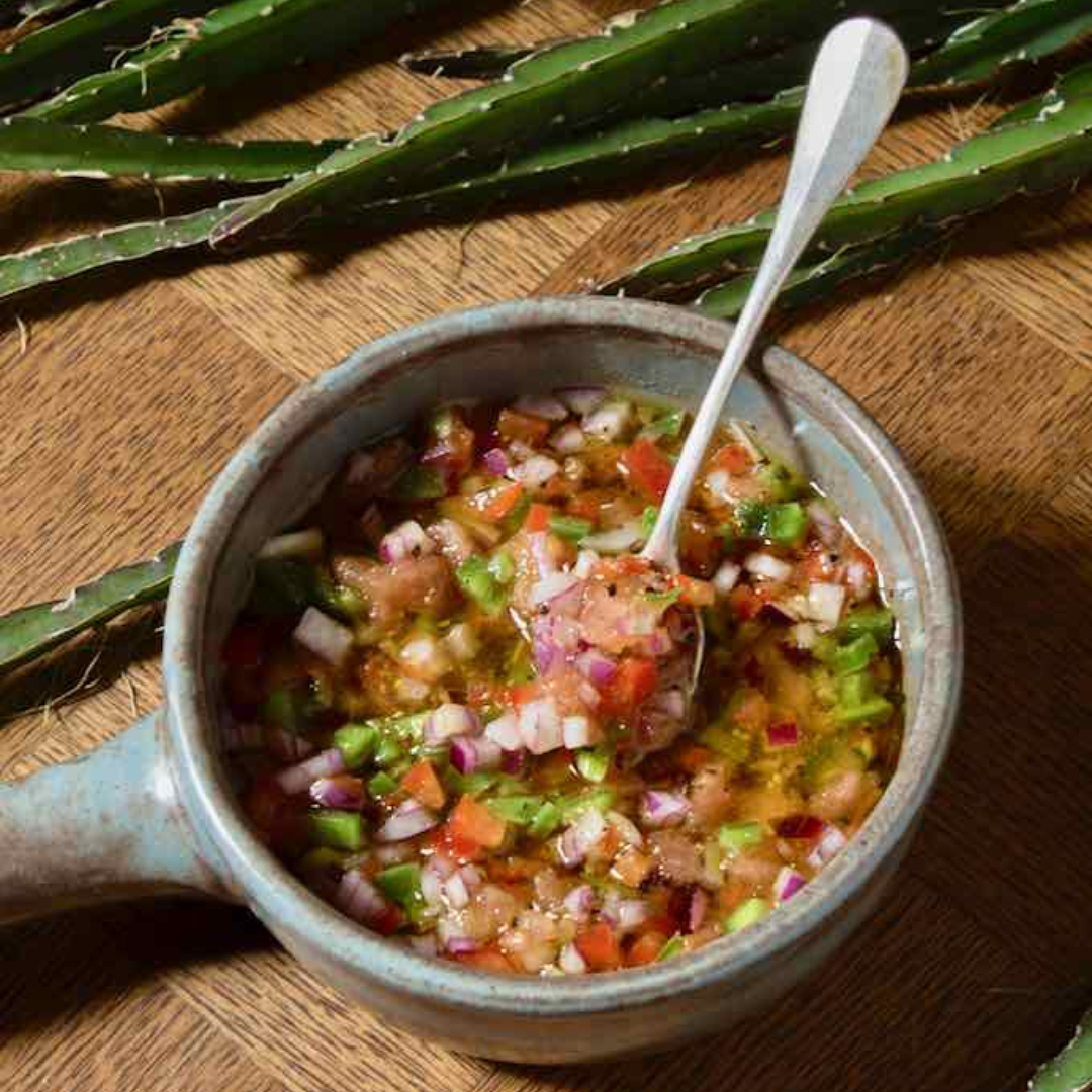 a bowl of food sitting on top of a wooden table