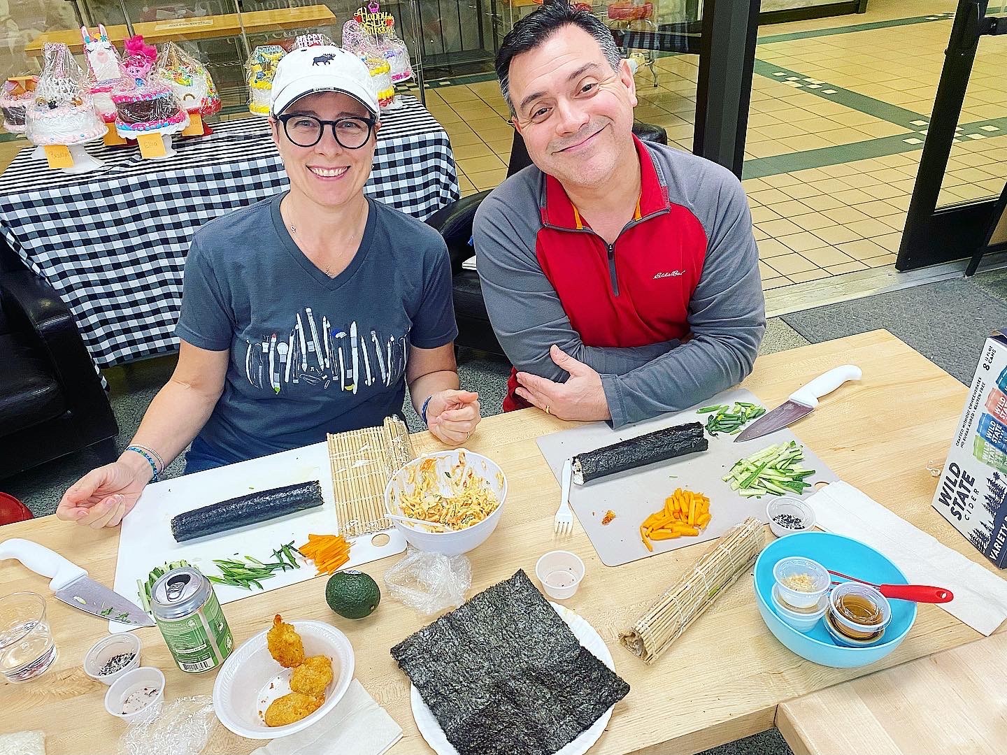 a group of people sitting at a table with food
