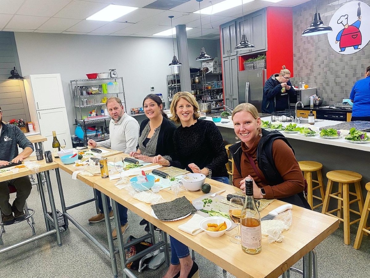 a group of people sitting at a table eating food