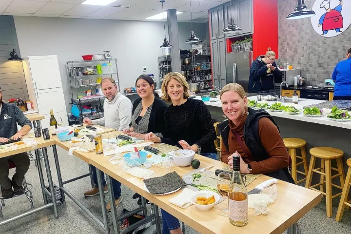 a group of people sitting at a table eating food