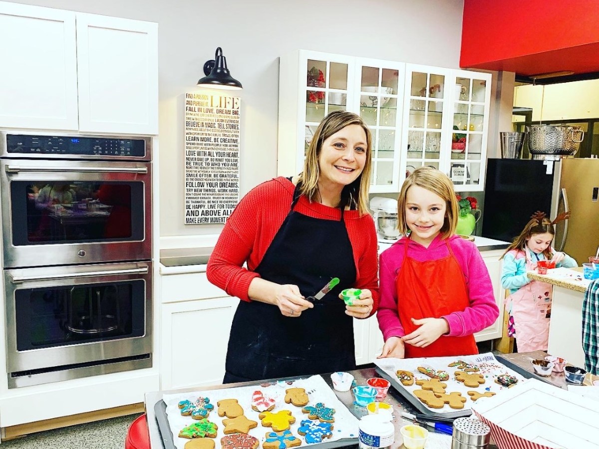 a person cutting a cake