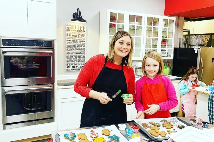 a person cutting a cake