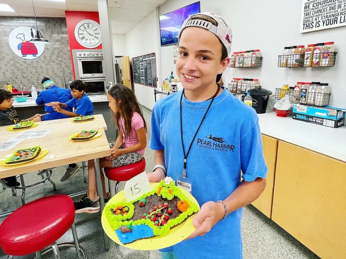 a person standing in front of a birthday cake