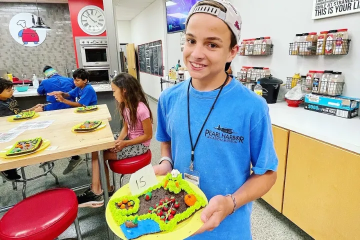 a person standing in front of a birthday cake