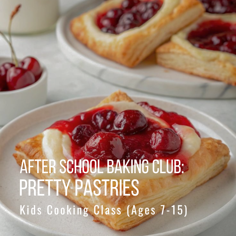 Pastries with cherry filling on a plate, cup with cherries beside them.