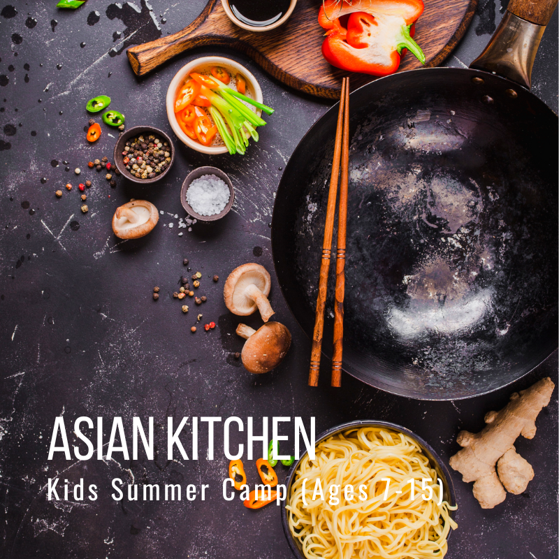 Ingredients for cooking in a rustic kitchen with vegetables, noodles, spices, and a wok on a wooden table.