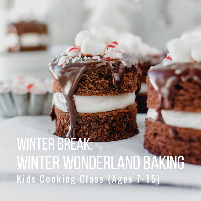 Two chocolate cakes with whipped cream and marshmallows on white background.