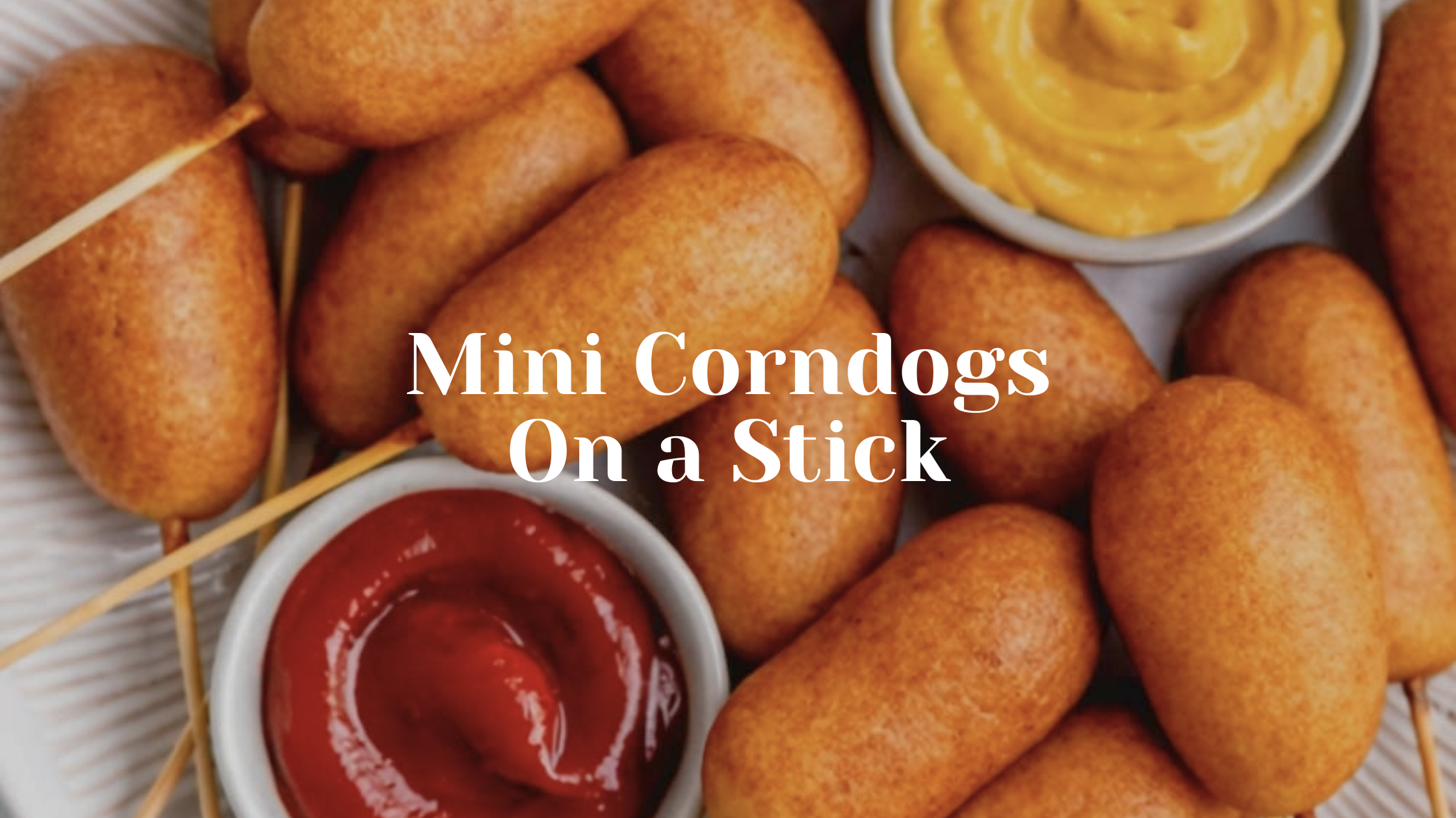 Mini corndogs on sticks with mustard and ketchup dips on a plate.